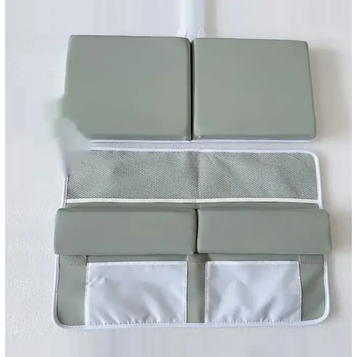 Gray padded baby safety mat with mesh and fabric storage pockets.