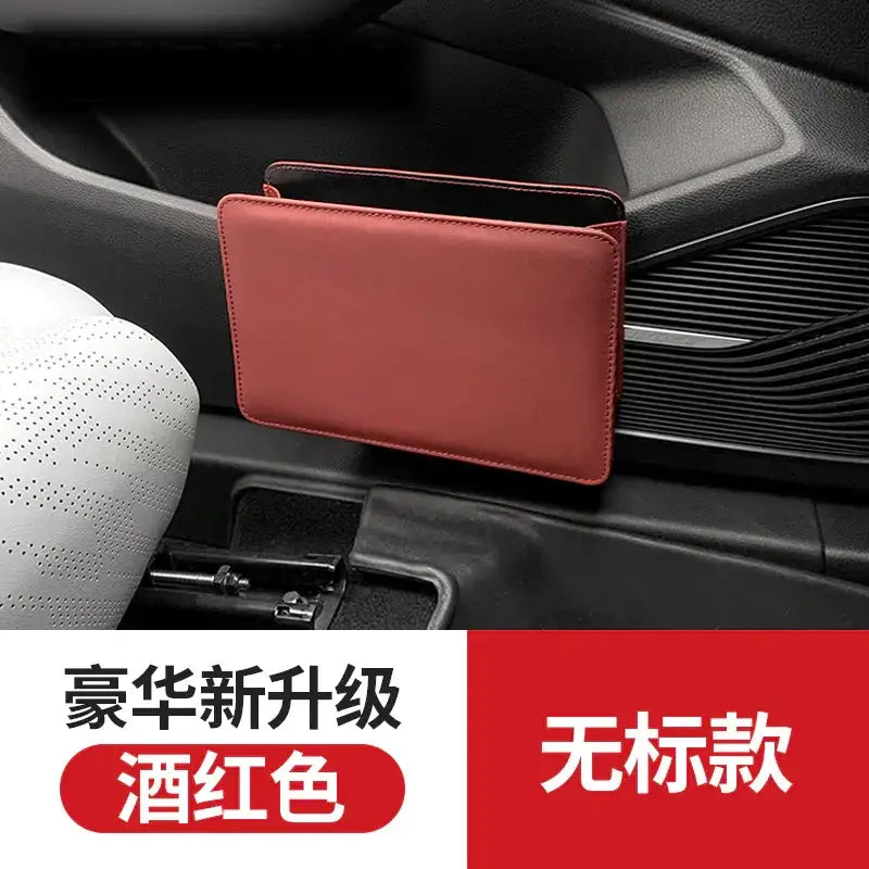 A sleek, wine-red leather car center console organizer with a minimalist design.