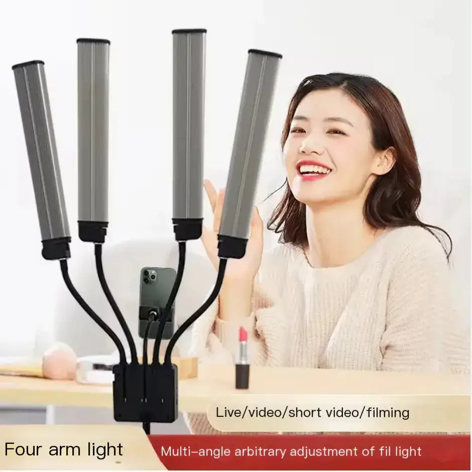 Silver-colored, four-armed led light with adjustable gooseneck arms and a phone mount for live streaming or video filming.