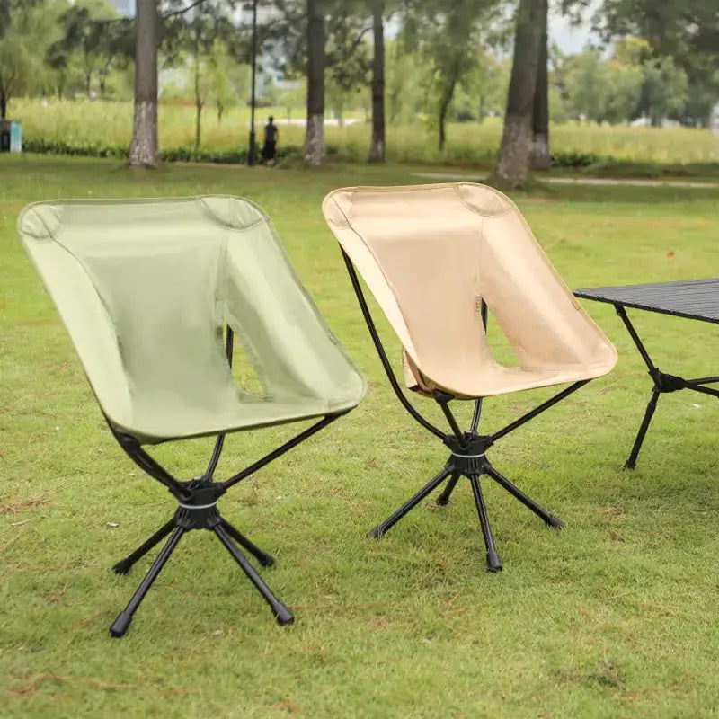 Two lightweight, foldable camping chairs with black metal frames and fabric seats in sage green and beige.
