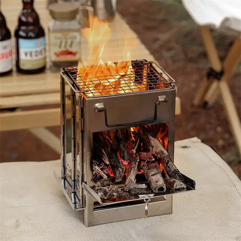 Portable stainless steel camping grill with mesh grate and open firebox