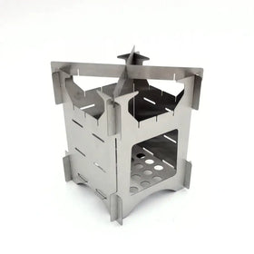 Silver stainless steel foldable camp stove with a castle-like design and perforated base.