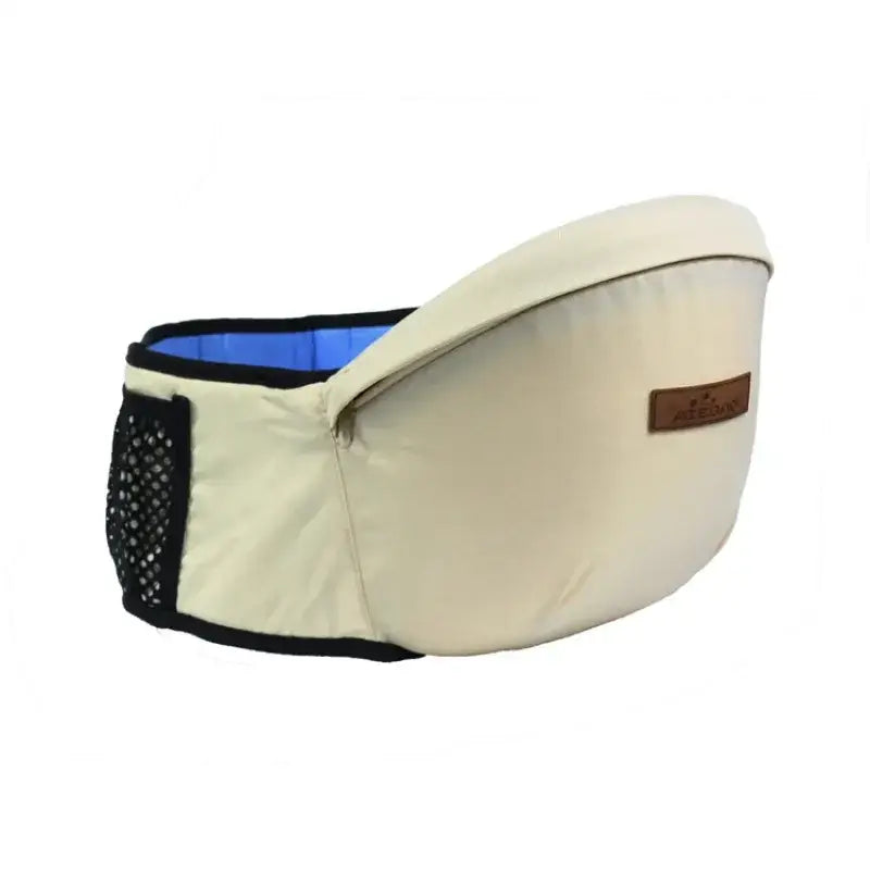 Beige baby carrier with black trim, blue interior lining, and a mesh pocket on the side.