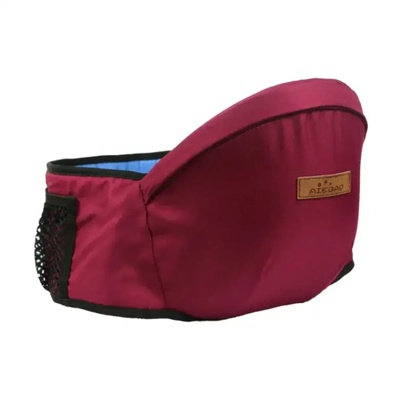 Maroon fabric baby carrier with black trim and mesh side pocket, featuring a blue interior lining.