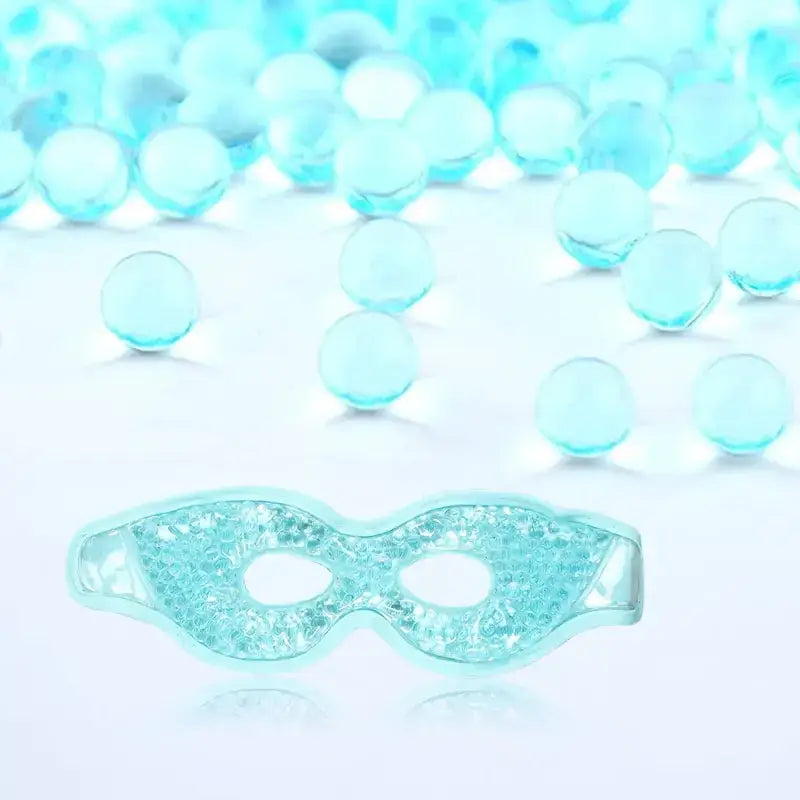 A translucent light blue gel-filled eye mask with a textured, crystalline surface.