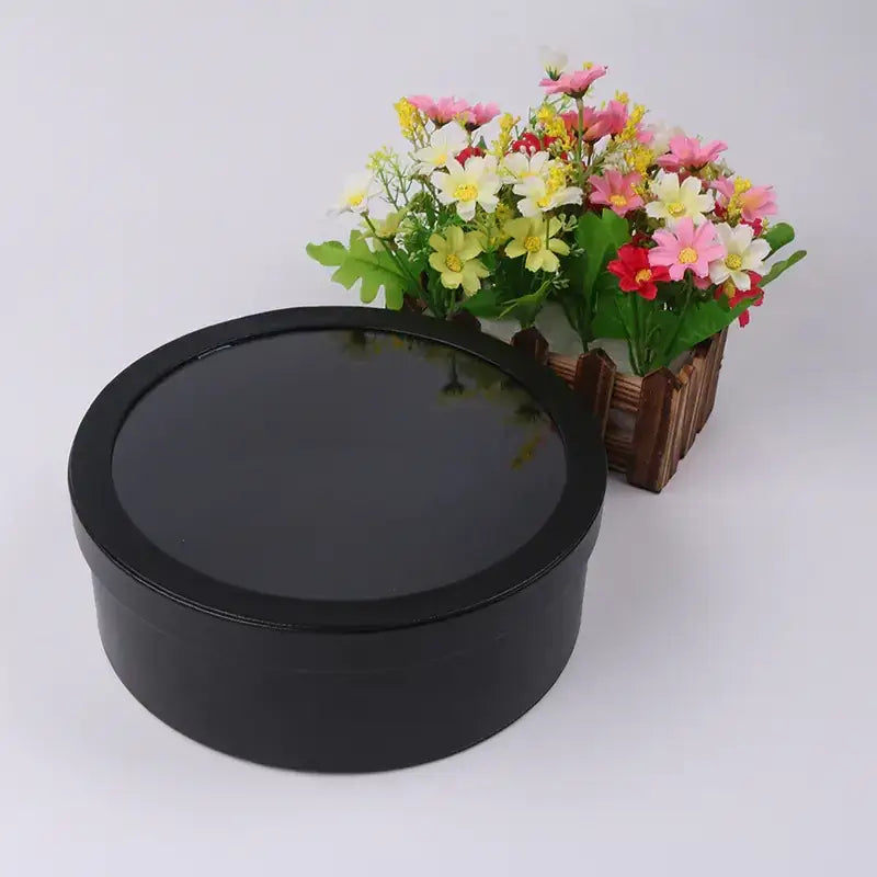 Black round gift box with a glossy finish.