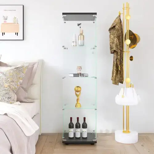 Clear glass display cabinet with black metal frame and shelves, showcasing various items including bottles of wine, a golden trophy, and cosmetic products.