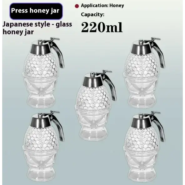 Clear glass honey jar with a textured, hexagonal pattern and a silver-toned metal top featuring a handle for pressing.