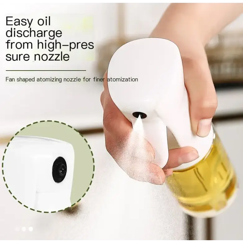 White plastic spray bottle with a fan-shaped nozzle designed for fine atomization, shown dispensing oil from its high-pressure tip.