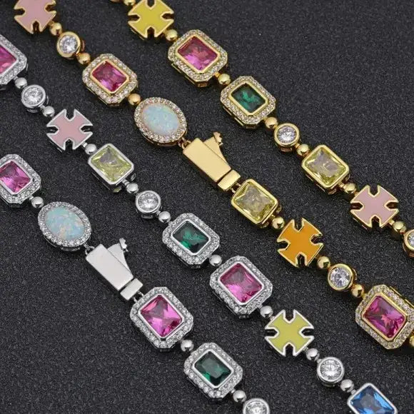 Colorful gemstone-encrusted bracelet with gold and silver-toned cross charms.