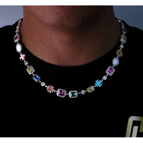 A vibrant, multi-colored gemstone necklace with silver-toned metal accents and cross-shaped charms.