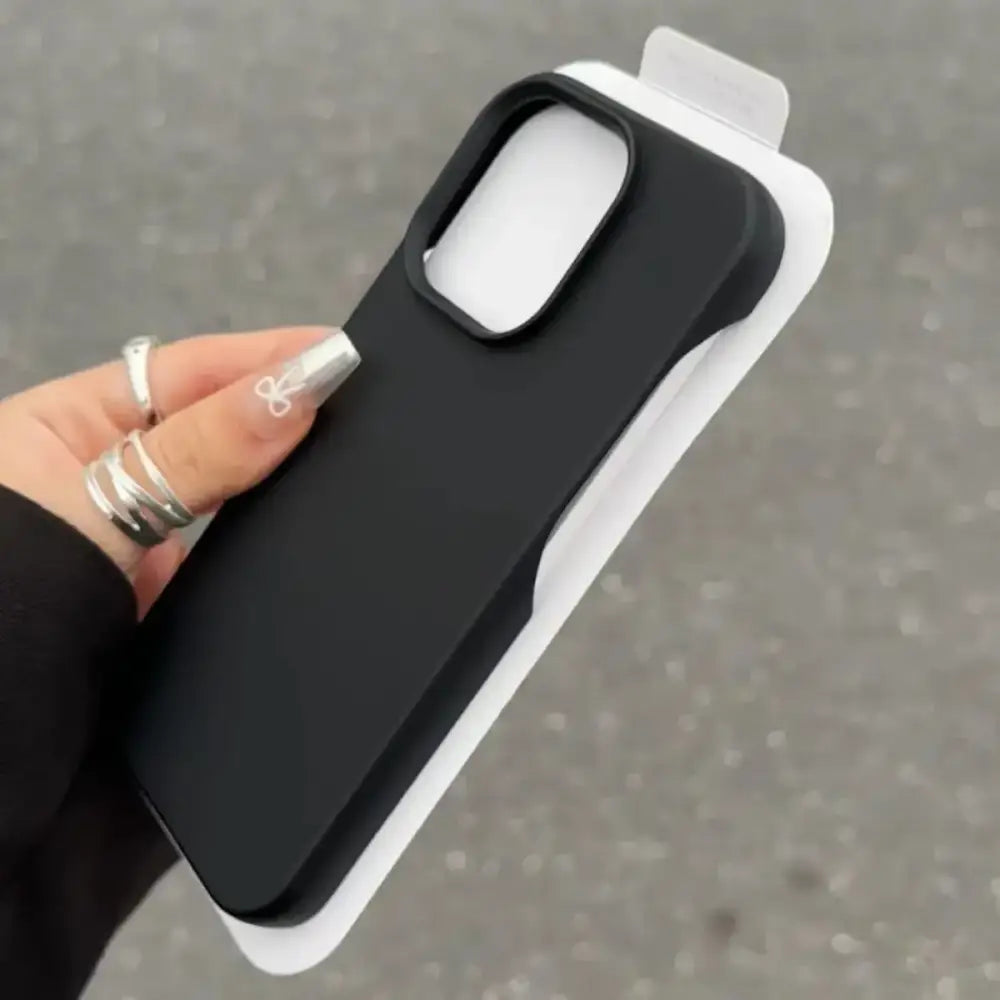 Black matte phone case with a white camera cutout and rounded edges.