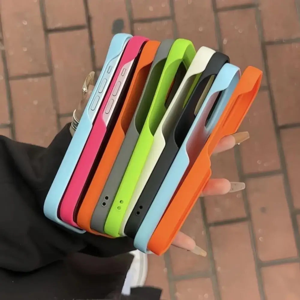A collection of colorful, slim-fitting phone cases in vibrant hues like light blue, pink, orange, lime green, gray, and black.