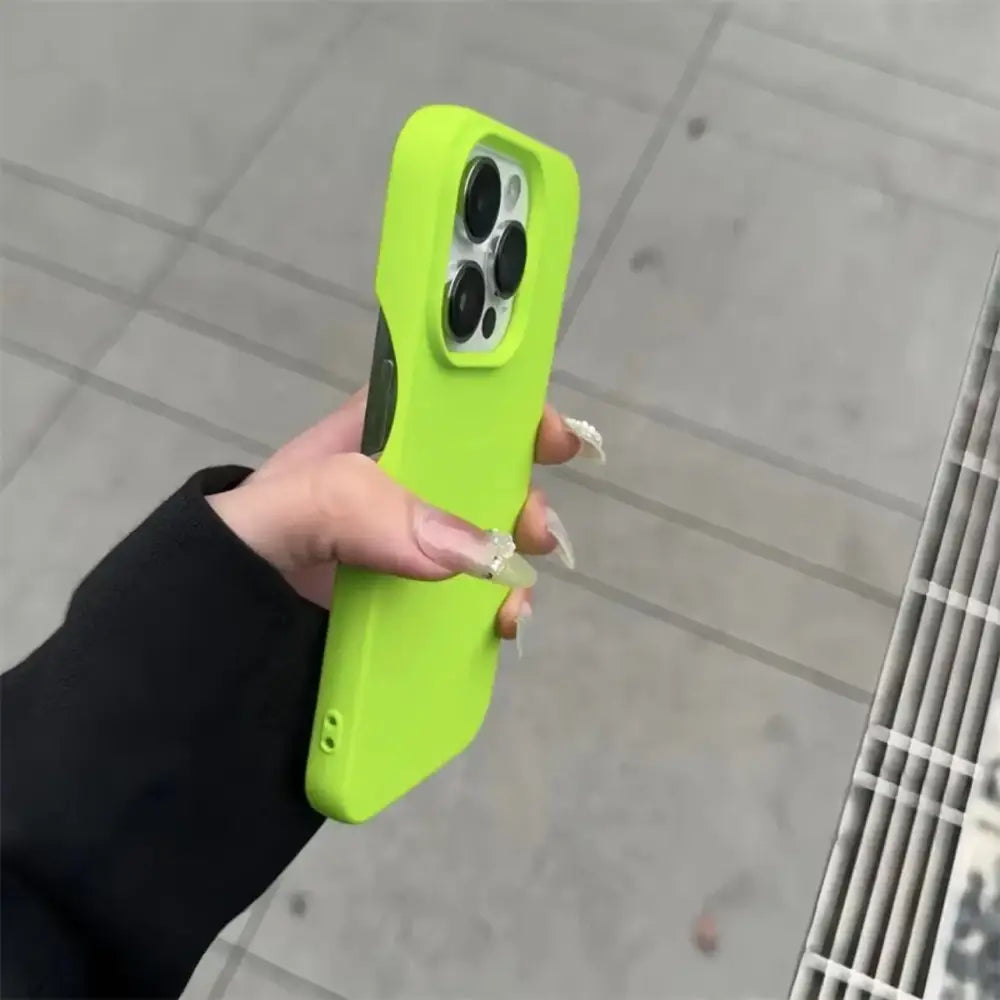 Vibrant lime green silicone phone case with a sleek, minimalist design that snugly fits an iphone pro model.