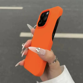 Bright orange silicone phone case with a matte finish, snugly fitted over an iphone 13 pro.