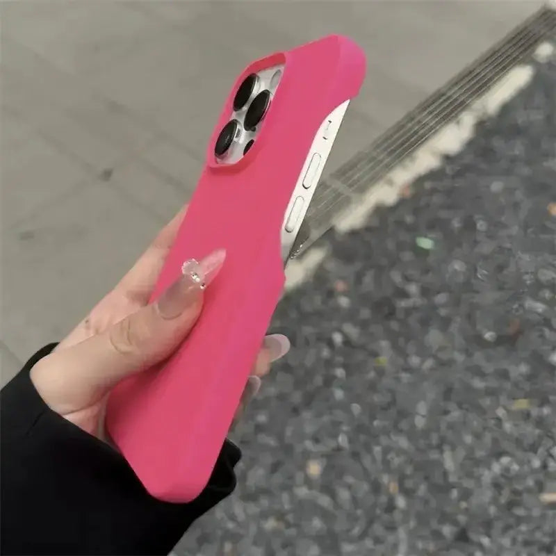 A vibrant pink silicone phone case with a smooth, matte finish and precise cutouts for the camera lenses.