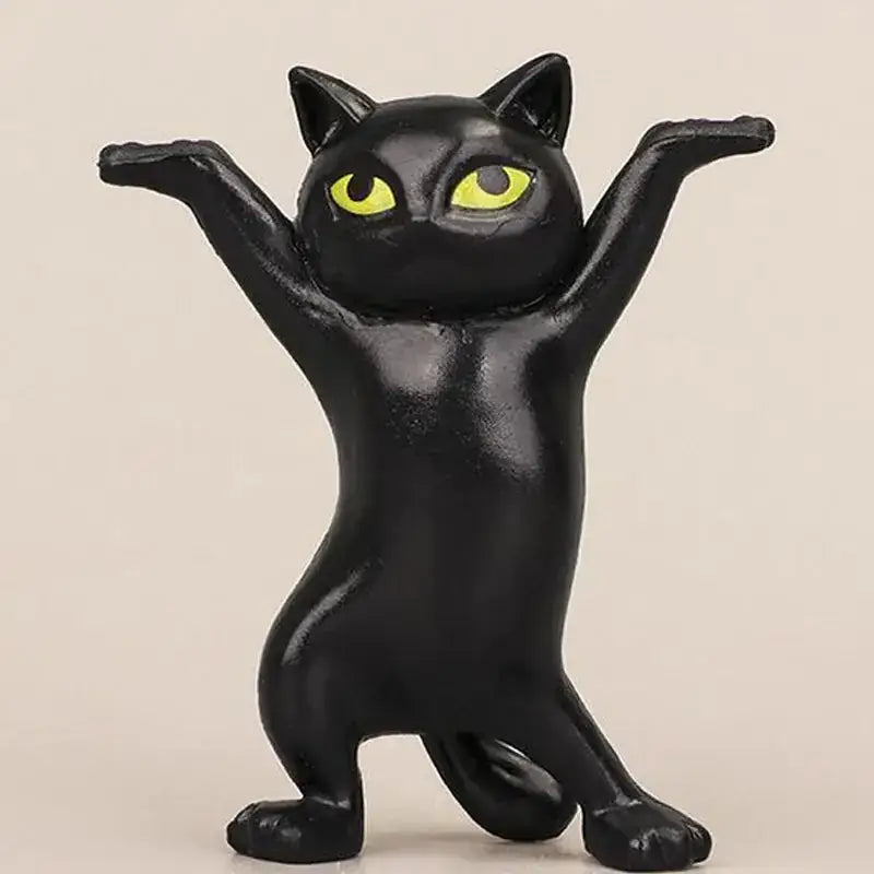 Black cat figurine with striking yellow eyes, crafted from glossy plastic.