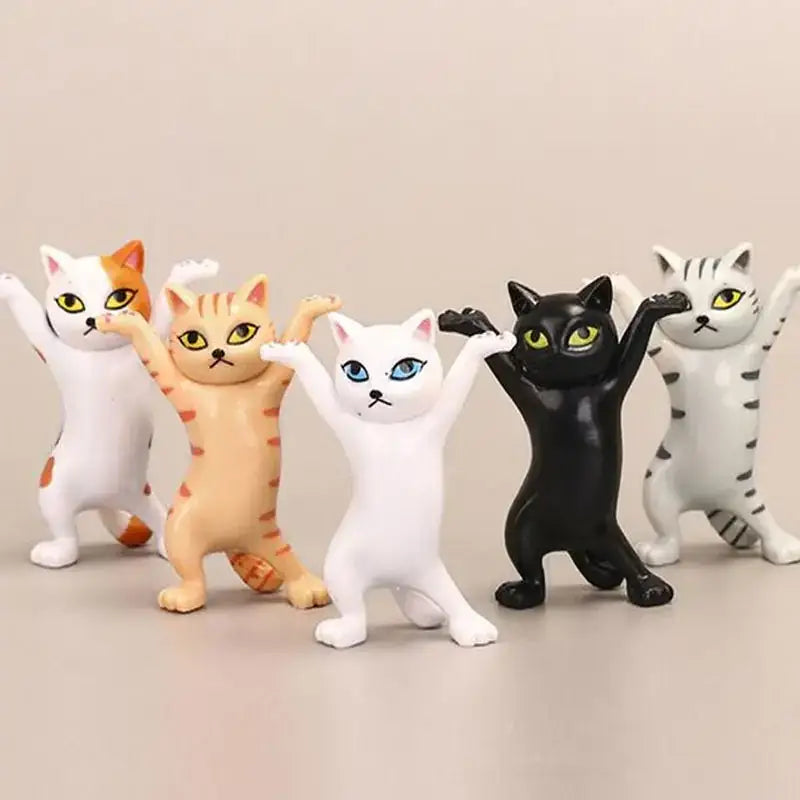 A set of five playful, standing cat figurines in various colors and patterns.