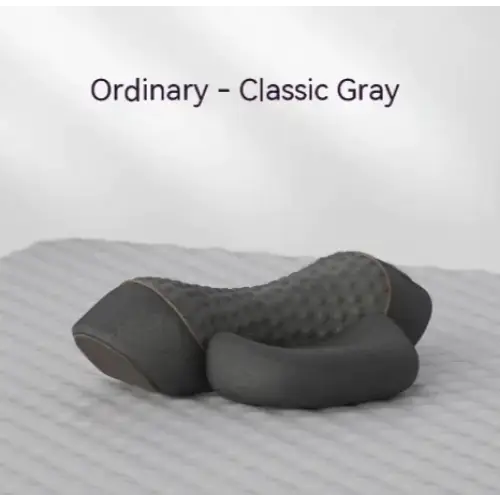 Classic gray ordinary neck pillow with a textured, dimpled surface and smooth contours.