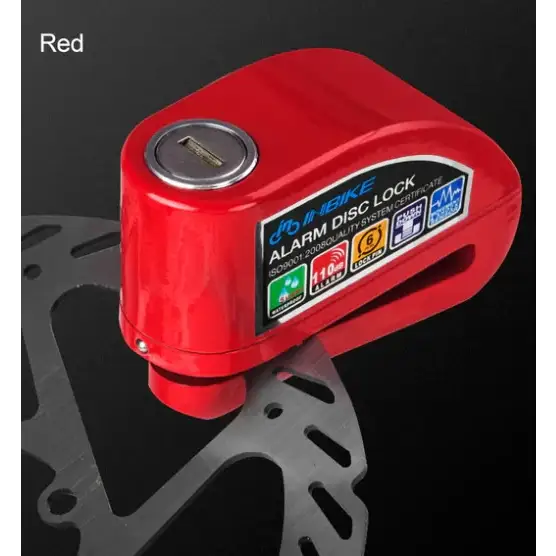 Red alarm disc lock with a metallic keyhole and labeled features on its surface.
