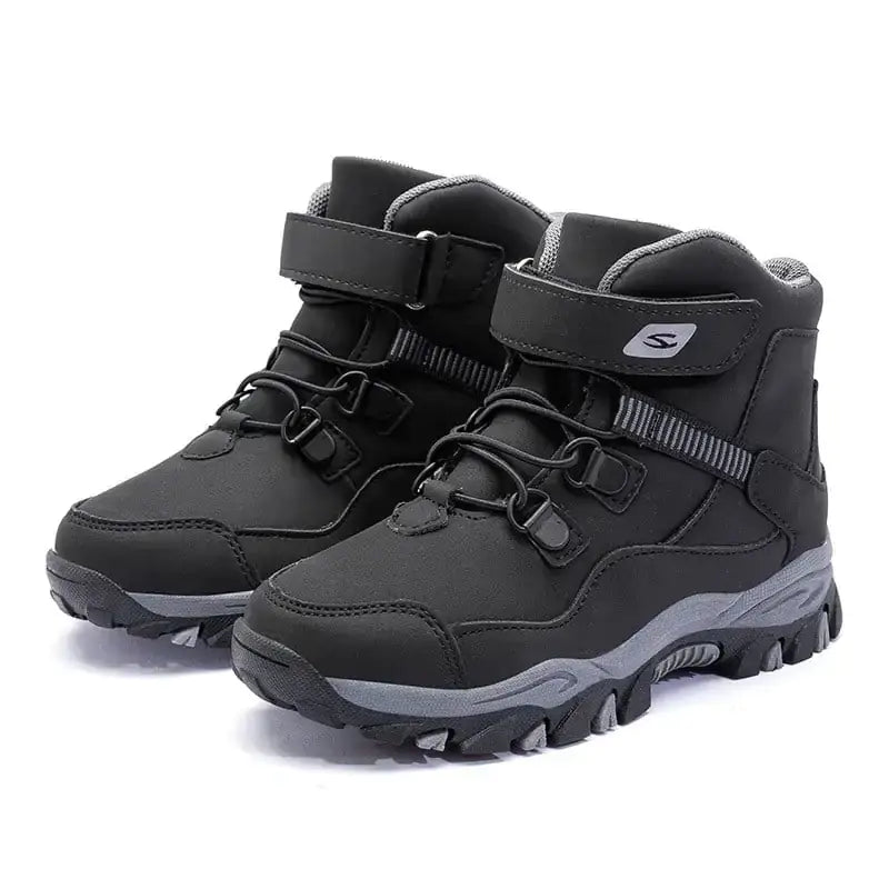 Black and gray children’s winter hiking boots with a durable rubber sole and adjustable strap closure.