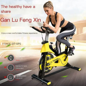 Yellow and black stationary exercise bike with a sleek, modern design.