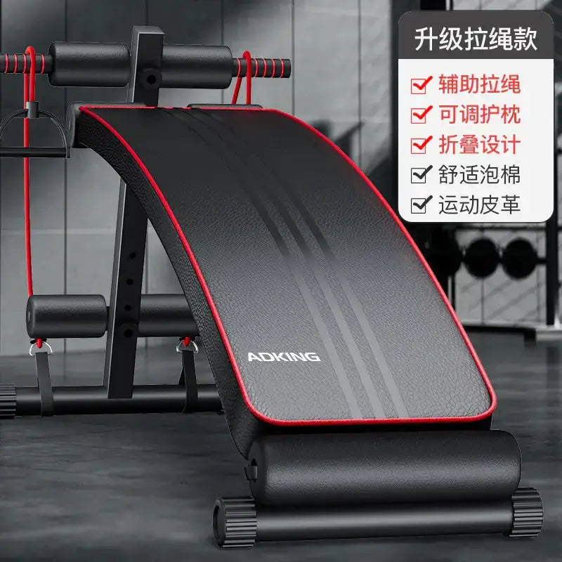 Black and red adking brand adjustable exercise bench with padded surface and built-in resistance bands.