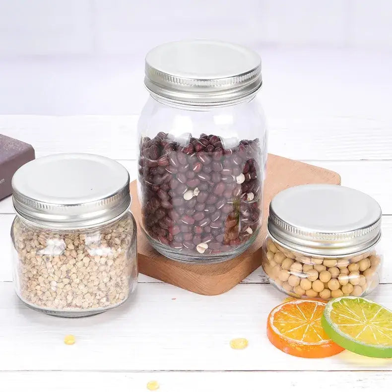 Clear glass mason jar with a silver metal lid, filled with dark red beans.