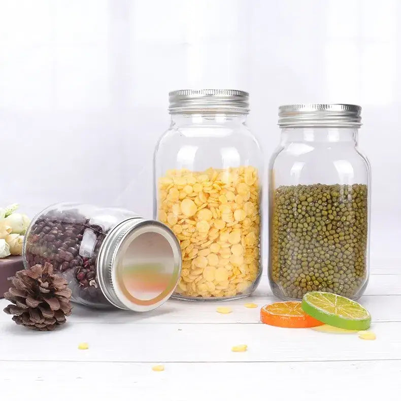 Clear glass mason jar with a silver metal lid, filled with yellow lentils.