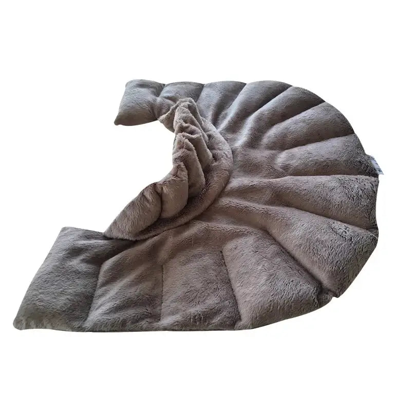 A plush, taupe-colored, quilted throw blanket with a soft, fuzzy texture and segmented, fan-like folds.