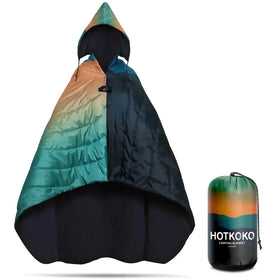 A vibrant gradient-colored hotkoko camping blanket with a hood, featuring teal, orange, and black hues in its quilted design.
