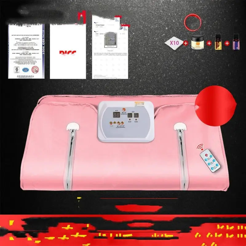 Pink fabric-covered infrared therapy blanket with a white control panel and remote.