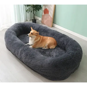 A cozy, dark gray plush dog bed with a soft, fluffy texture and an oval shape.
