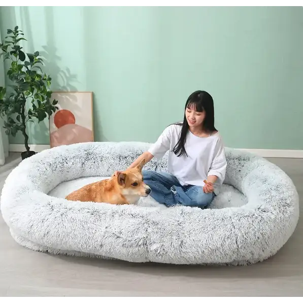 Fluffy white circular dog bed with a soft, plush texture and rounded edges