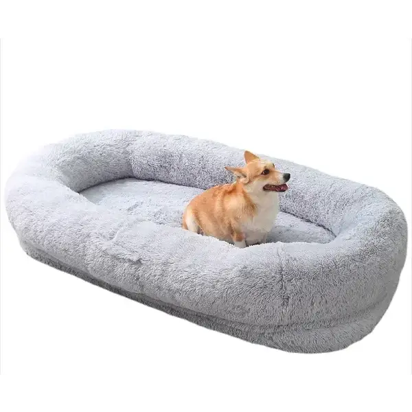 Gray plush oval dog bed with a soft, textured surface and raised edges.