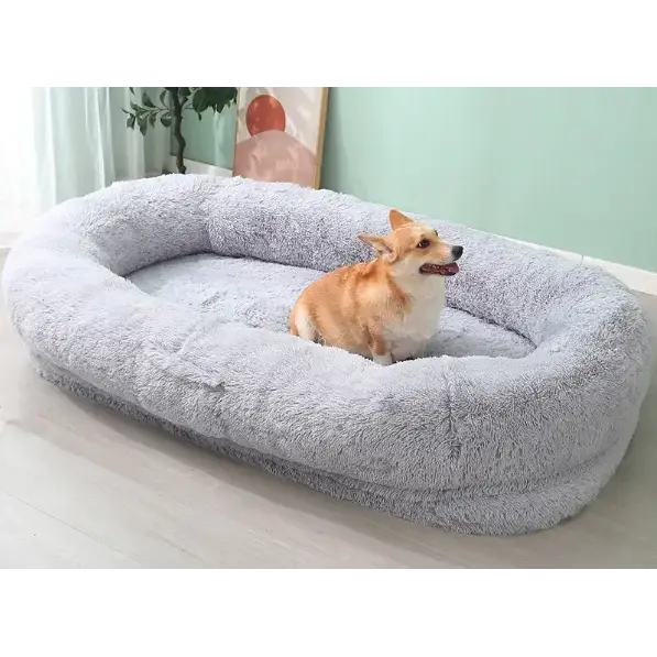 Soft gray plush dog bed with a cozy, oval-shaped design.