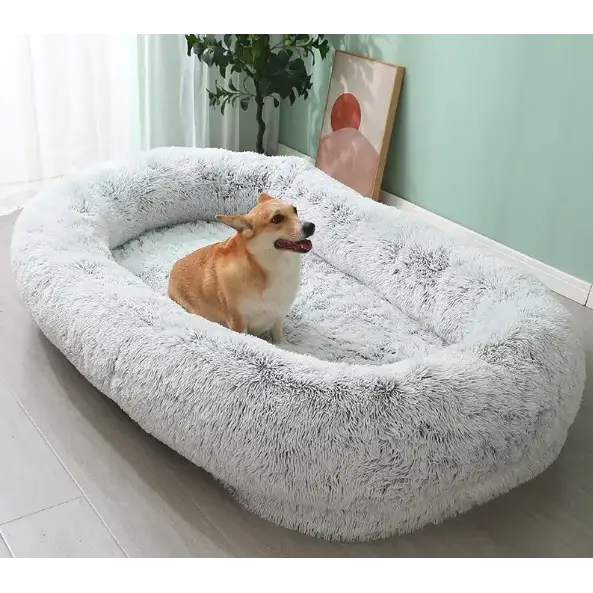 Soft, fluffy gray faux fur dog bed with a cozy oval shape.