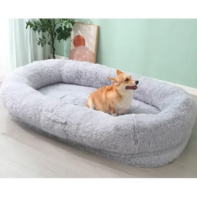 Soft, plush gray dog bed with a cozy, oval shape and high, cushioned edges.