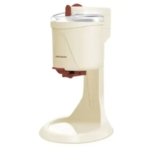 Cream-colored countertop ice cream machine with a clear lid and red accents on the handle and dispensing mechanism.