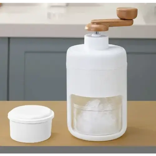 White plastic ice grinder with wooden handle and clear glass window, featuring a detachable white lid.