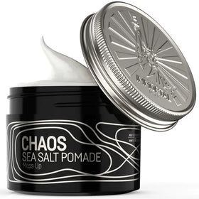 Black cylindrical jar with silver lid, featuring ’chaos sea salt pomade’ in white text on a sleek label.