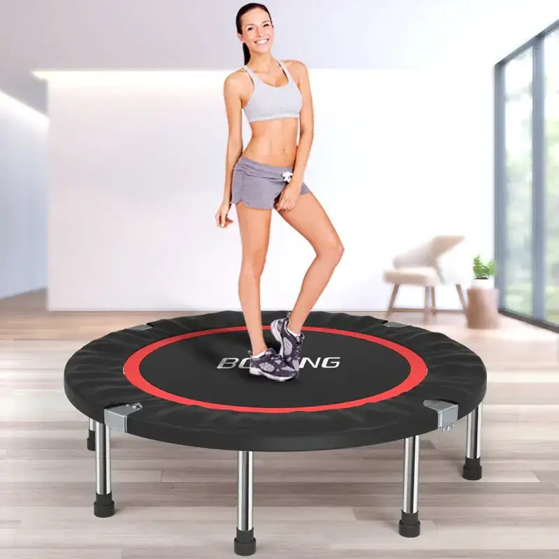 Black and red circular trampoline with silver metal legs