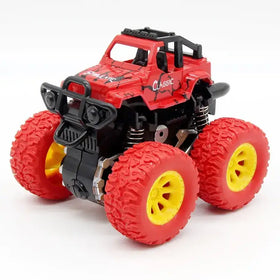Red and black plastic monster truck toy with yellow-rimmed tires.