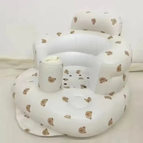 White inflatable baby chair with beige bear face patterns.