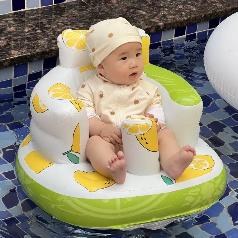 A white and lime green inflatable lemon-themed baby pool float chair with yellow citrus slice patterns.