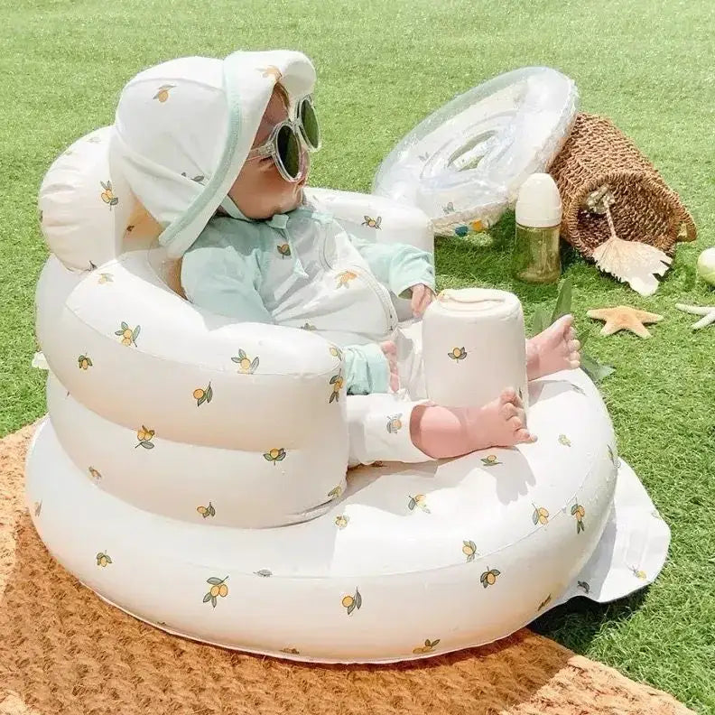 White inflatable baby seat with lemon and bee patterns
