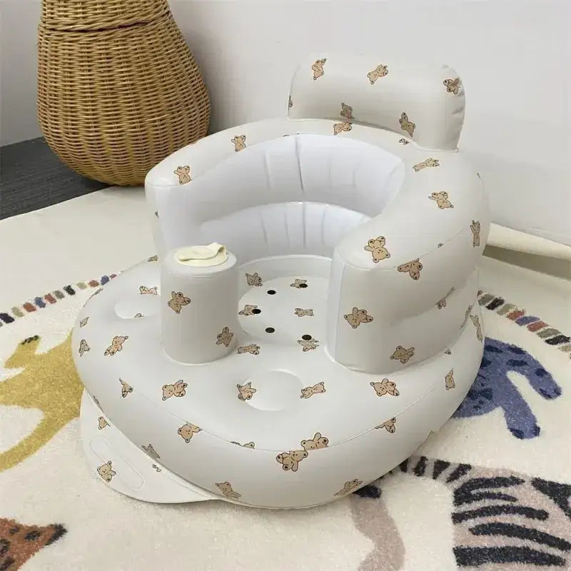 White inflatable baby seat with a teddy bear pattern.