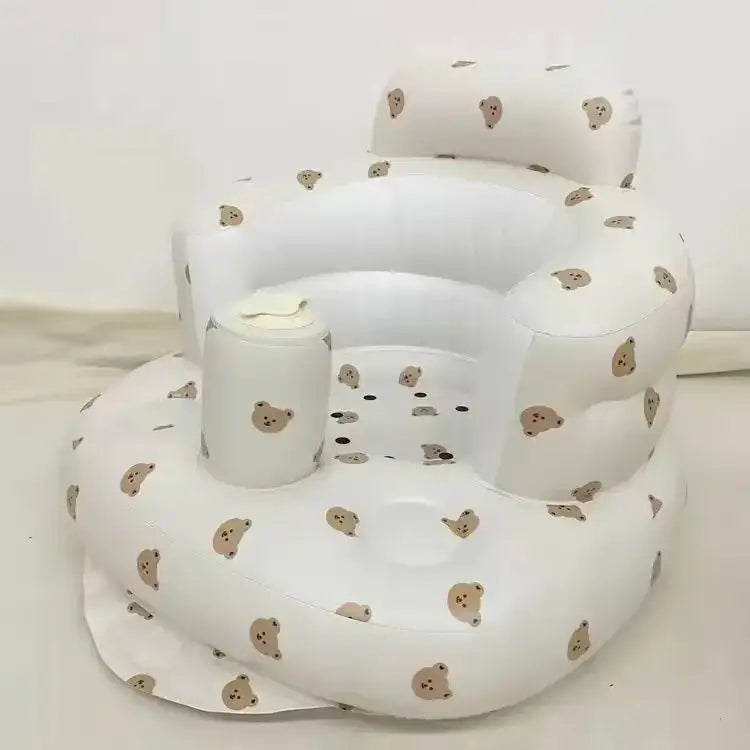 White inflatable baby chair with a soft, plush texture and scattered brown bear face patterns.