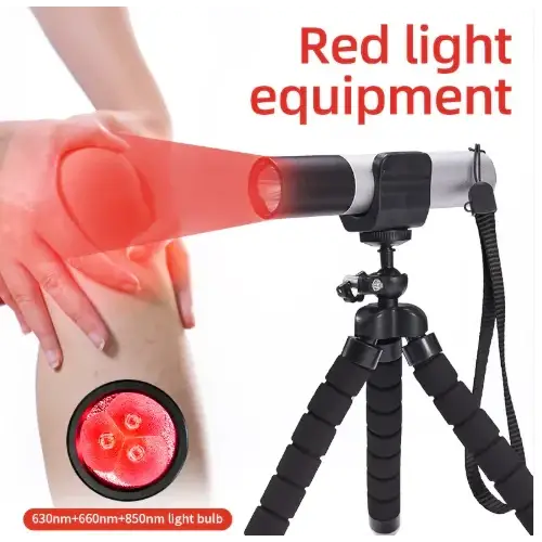 Black and silver tripod-mounted red light therapy device with a cylindrical head emitting targeted red illumination.