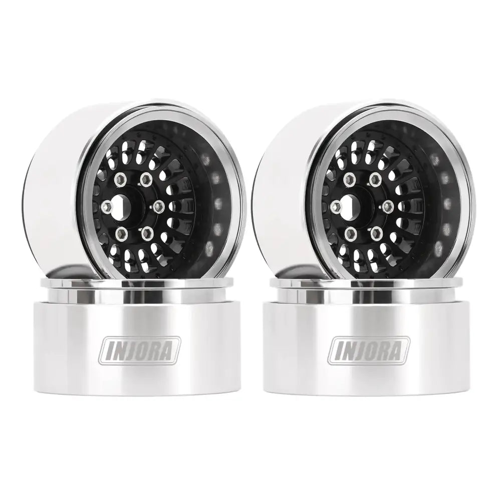 Pair of silver and black rc truck wheels with a sleek, polished metallic finish.
